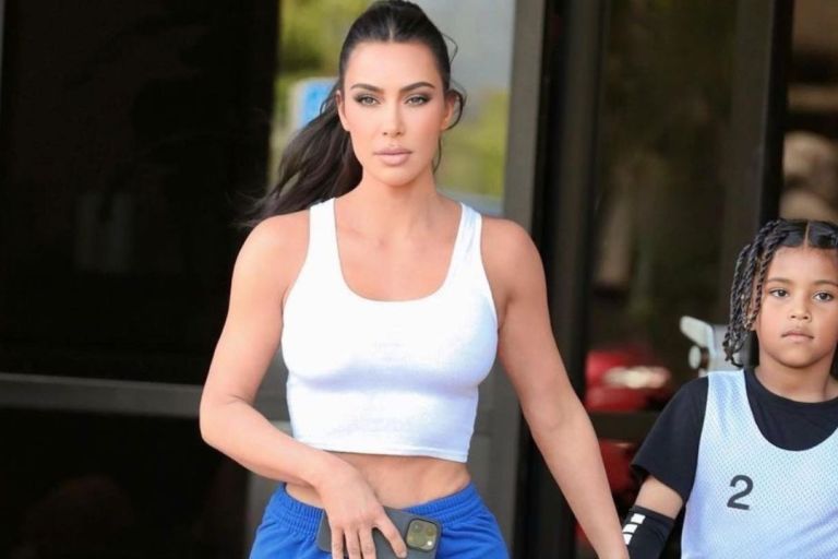 Kim Kardashian Wore a White Crop Top and Blue Sweatpants with Travis Scott Air Jordan 1’s to Saint West Basketball game in L.A.